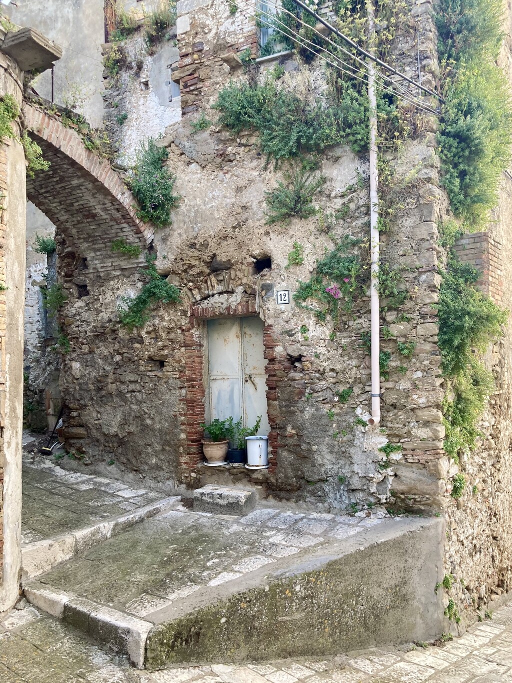 The arch on the left, which goes over the entry to the yard, is also a staircase that leads to the second story entry of the building next door.   